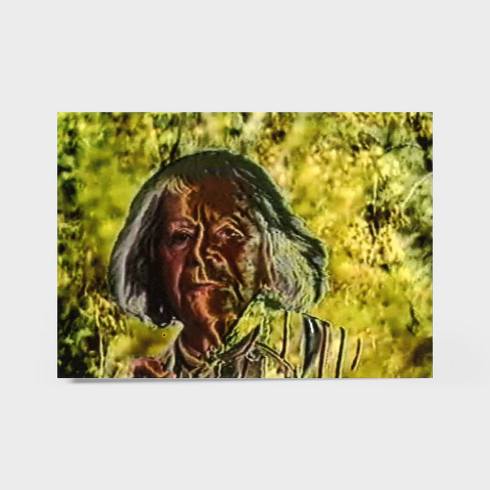 Steina Vasulka with long hair and a striped shirt against a yellow background