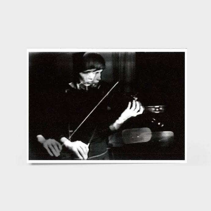 Black and white photo of a person playing the violin.
