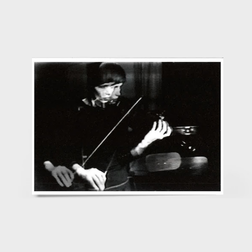 Black and white photo of a person playing the violin.